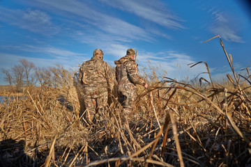 Two hunters preparing for duck hunting
