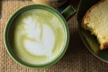 Matcha latte with butter cake breakfast on the marble background