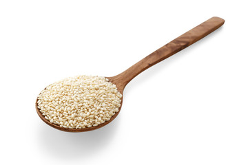 White sesame on wood spoon on white background