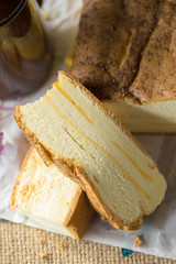 Hot tea cup and butter cake on Sack background