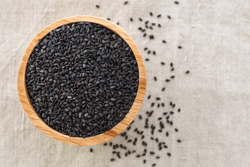 Black sesame in wood bowl background with space