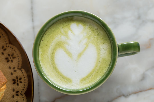 Matcha latte with butter cake breakfast on the marble background