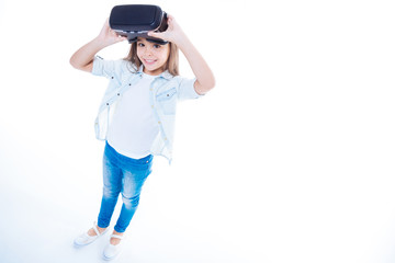 Cute positive girl using latest technology