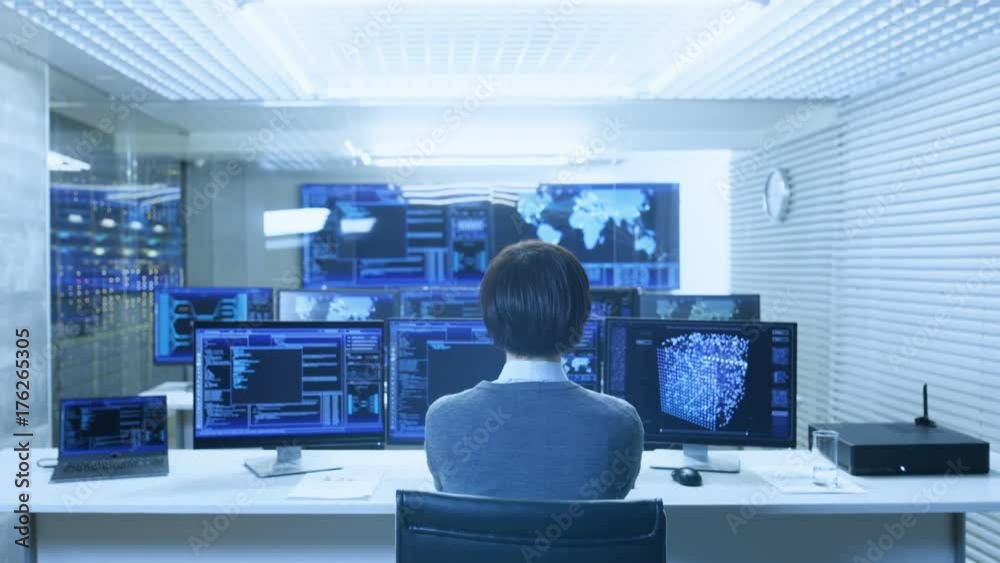 Poster Back View of the IT Engineer Working with Multiple Monitors Showing Graphics, Functional Neural Network. He Works in a Technologically Advanced System Control Data Center.