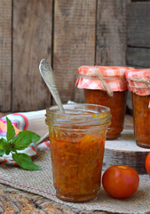 Jars of tomato sauce with chili, pepper and garlic. Bolognese sauce, lecho or adjika. Preservation. Canning