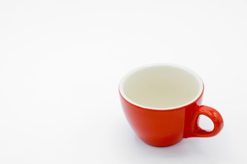 red ceramic cup on white background