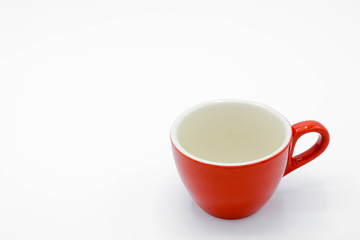 red ceramic cup on white background