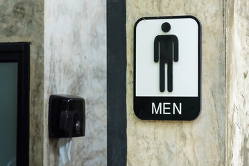 Men bathroom sign on concrete walls.