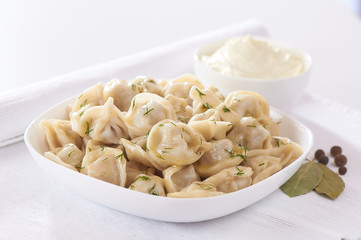 Russian cuisine hot meat dumplings served with herbs