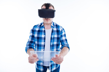 Smart serious man holding an innovative tablet