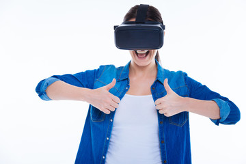 Positive cheerful woman showing thumbs up gestures