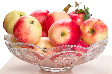Ripe apples in a crystal vase