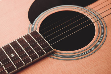 Obraz premium Close Up shot photo of Classic acoustic guitar with filter effect retro vintage style
