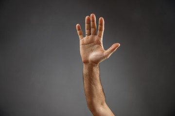 Fototapeta premium hand on a gray background. open palm