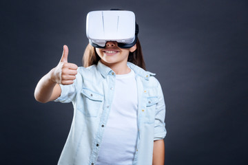 Delighted cheerful girl showing OK gesture