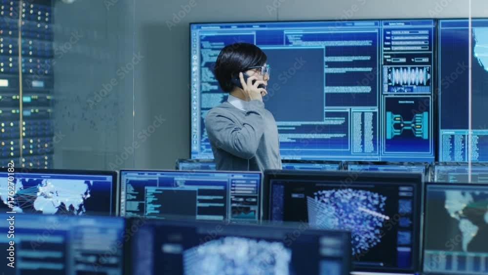 Poster In the System Control Room IT Administrator Talks on the Phone. He's in a High-Tech Facility That Works on the Surveillance, Neural Networks, Data Mining, AI Projects.