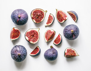Fresh figs. Food Photo. Creative scheme of the whole and sliced figs on a white background,...