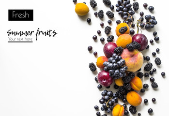 Creative  layout  of fresh summer fruits on a white background with space for text. Plum, blackberry, grapes, peach, apricot. View from above