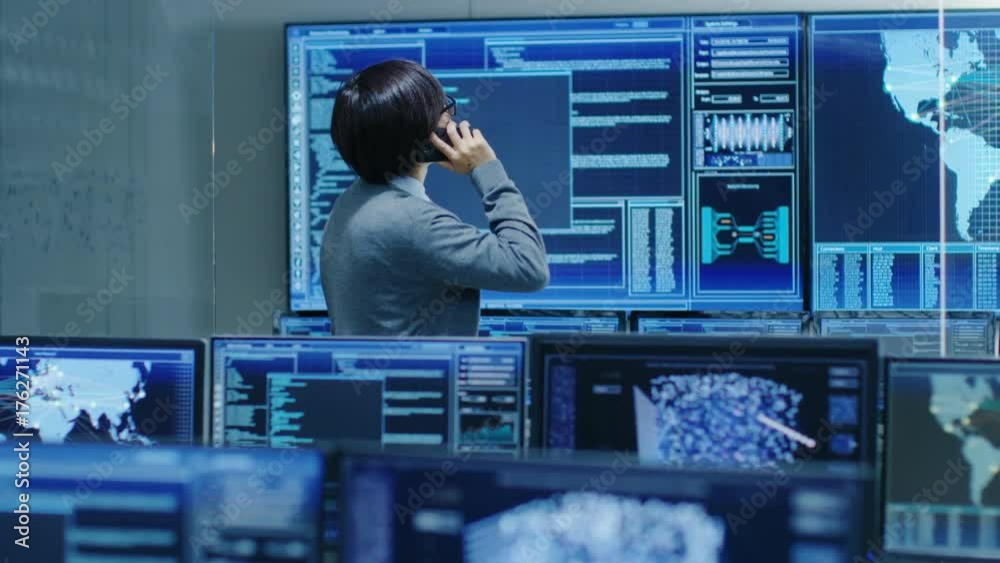 Poster In the System Control Room IT Administrator Talks on the Phone with His Superiors. He's in a High-Tech Facility That Works on the Surveillance, Neural Networks, Data Mining, AI Projects.