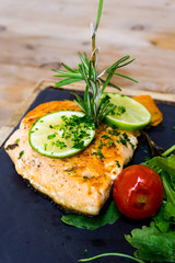 grilled salmon and lemon - french cuisine dish with tomato and salmon