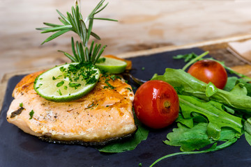 grilled salmon and lemon - french cuisine dish with tomato and salmon
