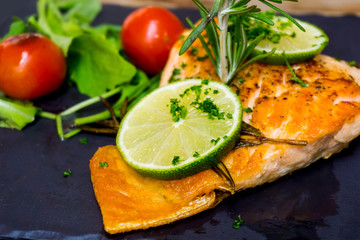 grilled salmon and lemon - french cuisine dish with tomato and salmon
