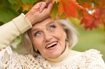 woman holding autumn leaves 