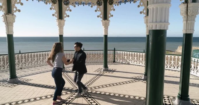 Aerial view of caucasian young couple dancing salsa in the Victorian bandstand in Brighton