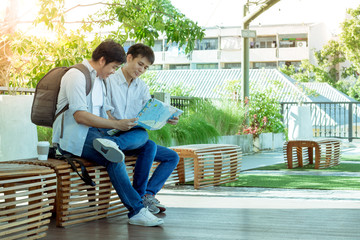 Two men are planning a trip to see the tourist map in Thailand.