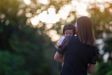 Asian woman carry her baby for love.