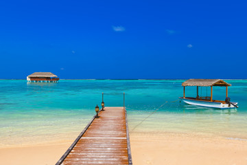 Boat and bungalow on Maldives island