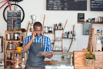 Young African entrepreneur hard at work in his trendy cafe