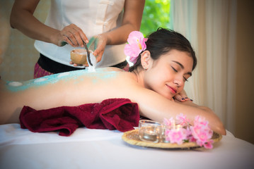 Obraz na płótnie Canvas Masseur doing massage spa with treatment salt and sugar on Asian woman body in the Thai spa lifestyle, so relax and luxury. Healthy Concept