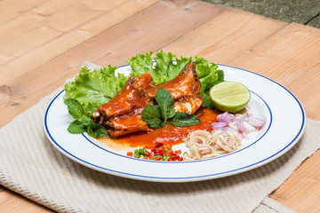 Mackerel fish in tomato sauce and cook in Thai spicy salad.