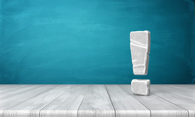 3d rendering of a grey-white exclamation mark made of stone standing on a wooden surface in front of blue background.
