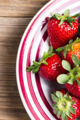 Strawberries plate on a wooden table