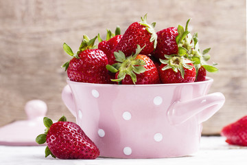 Fresh strawberries in a sweet pink bowl