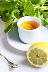 Tea with lemon and mint in the background