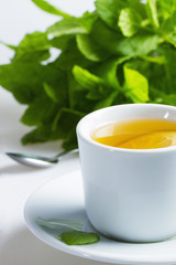 Hot mint tea with lemon on a white background