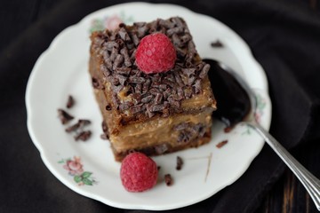 Fototapeta na wymiar Delicious chocolate cake with raspberries on the table