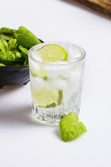 Refreshing mojito drink in a elegant glass on white