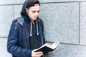 Young teenager reading a book