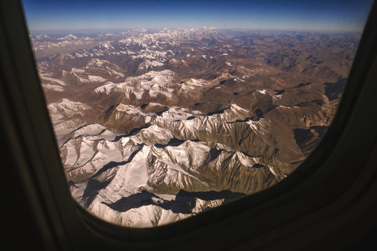 Fototapeta Top view image of the Himalaya mountain and blue sky horizon from airplane window