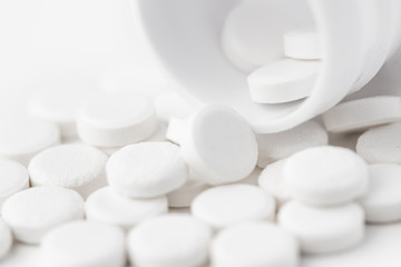 White pills on white background