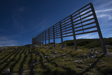 The shadow of a long fence