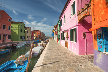 Fototapeta na wymiar Colourful buildings lining cannal, Island of Burano, Venice Italy
