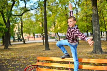 The young guy sits on a bench in park