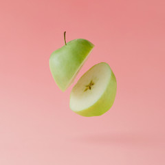 Apple sliced on pastel pink background. Minimal fruit concept.