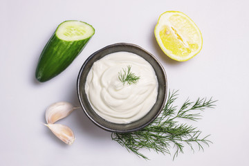 Tzatziki sauce ingredients on white, top view
