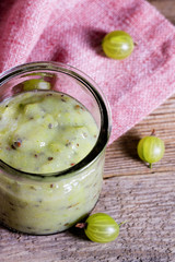 Gooseberry smoothie in a glass jar on pink napkin